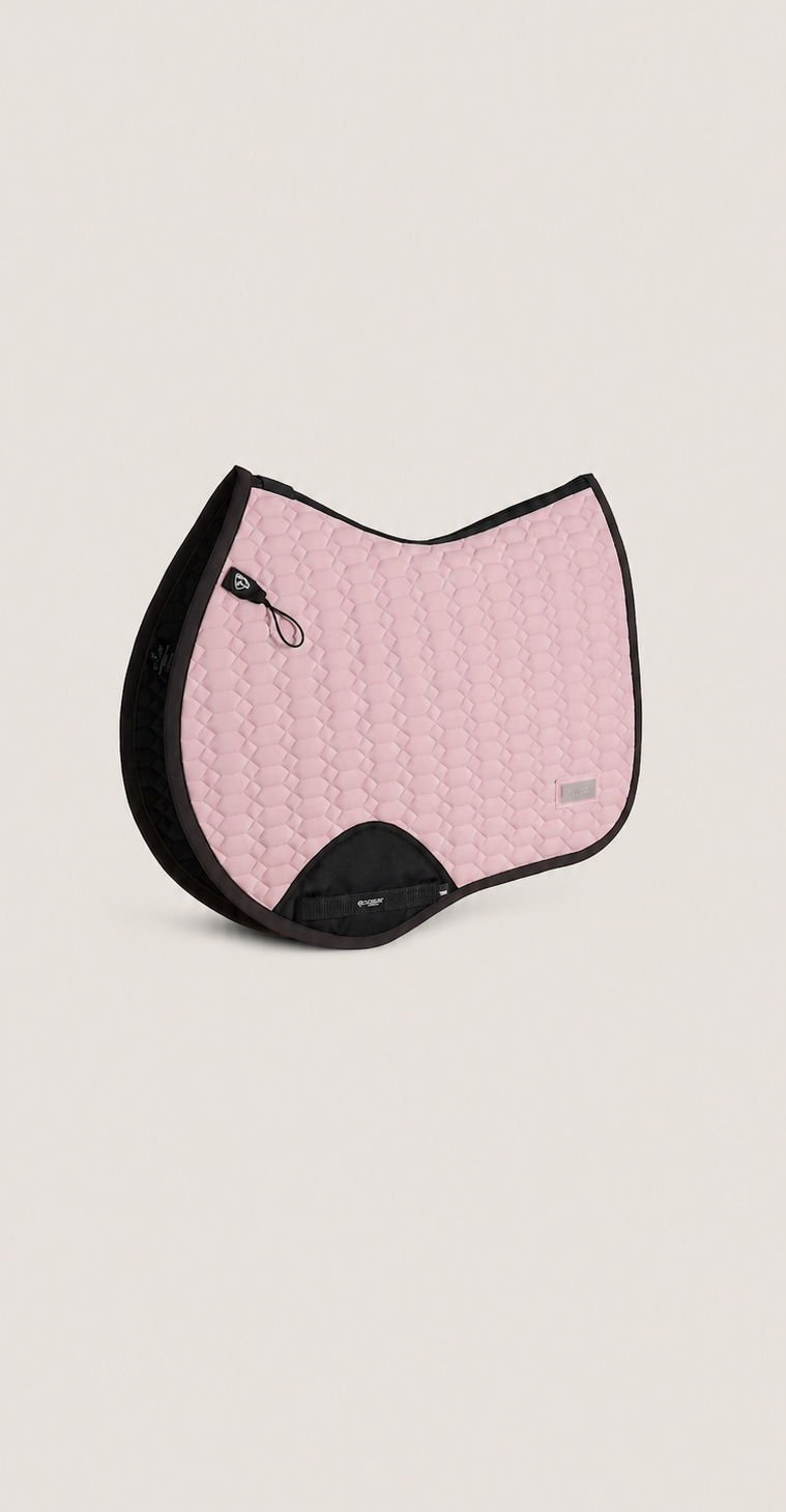 A light pink quilted equestrian saddle pad with black trim and a black center gore, shown on a solid light beige background.