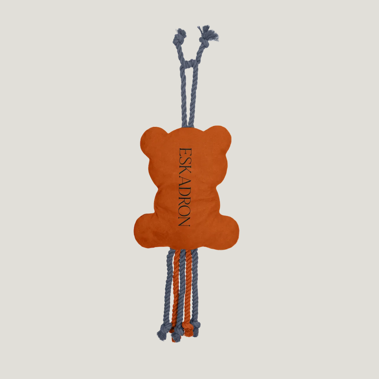 Orange bear-shaped dog toy with 'ESKADRON' branding on a white background