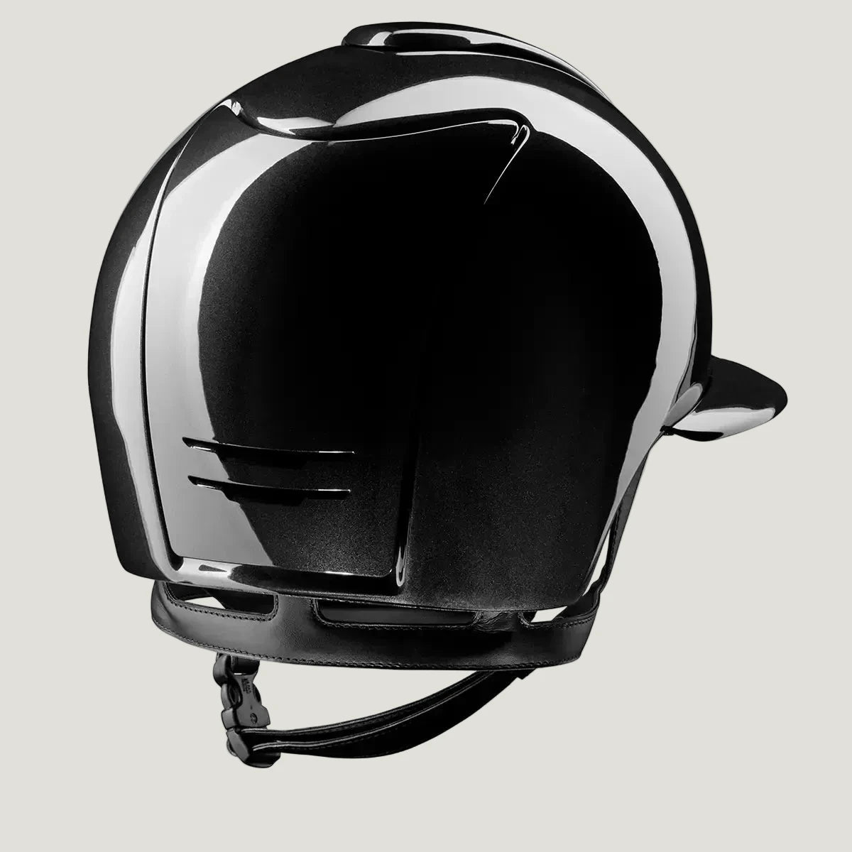 Black horseback riding helmet with a reflective visor on a white background
